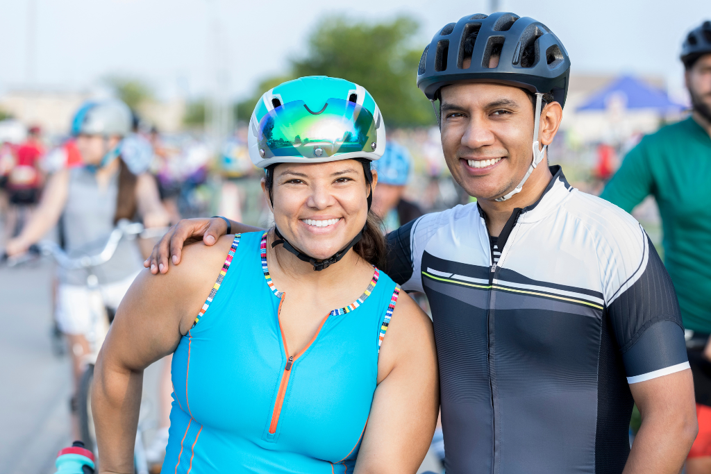 bicycle riders standing together smiling