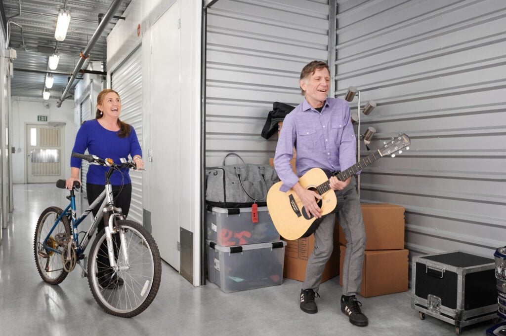 couple moving items into climate control storage unit