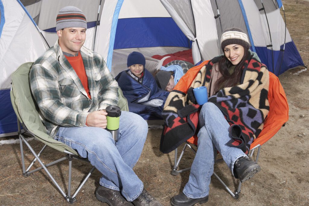 Happy Family Of Four Camping Together