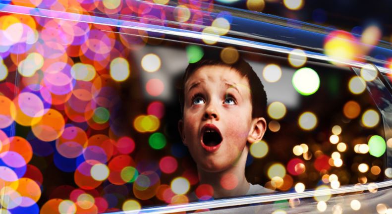 Child looking at holiday lights