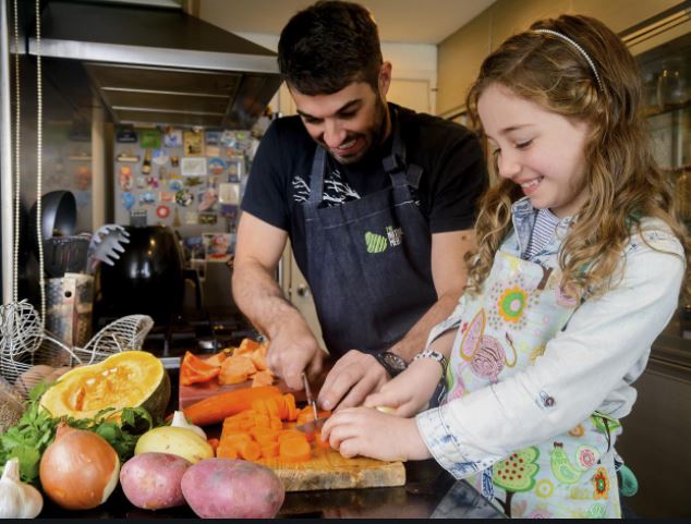 Father and daughter cooking healthy