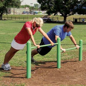 Individuals doing push-ups at a playground exercise bar during their workout session. Newbury park storage experts share tips to working out.  