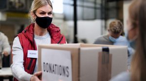 woman gives box of clothes. 