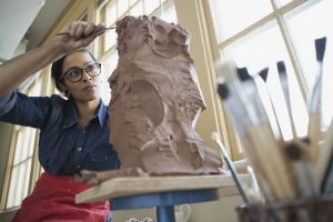 woman sculpts clay. Self-storage Thousand Oaks share the benefits. 