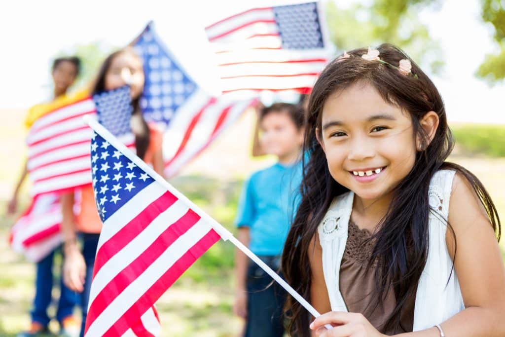 Cute little girl holds American Flag