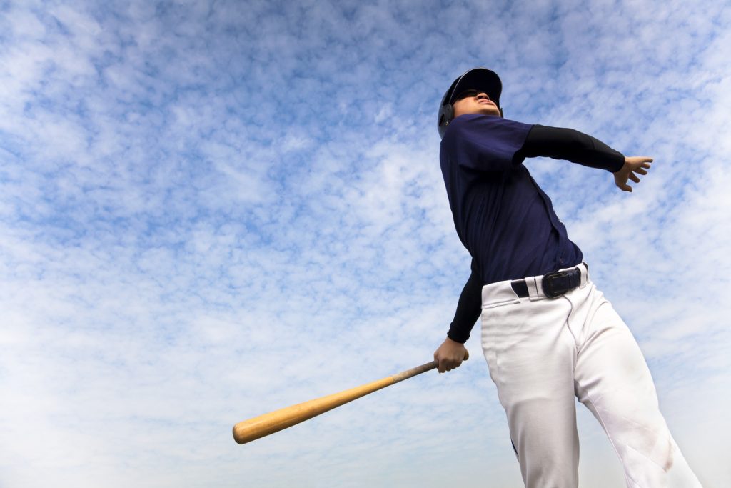 baseball player taking a swing with cloud background. Thousand Oaks storage experts share fourth of July events happening around town. 