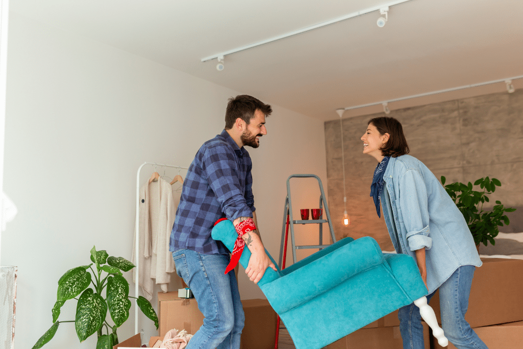 Newbury-Park-furniture-cleaning A person and person holding a blue chair for Newbury Park Storage units.