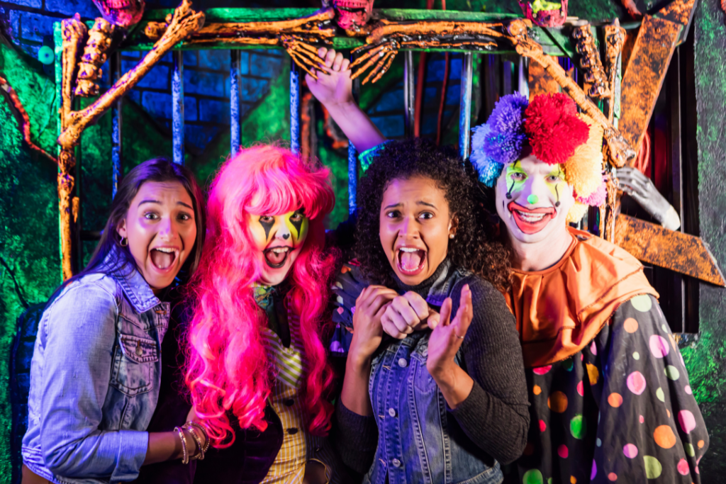 Teens dressed up for Halloween, looking scared.