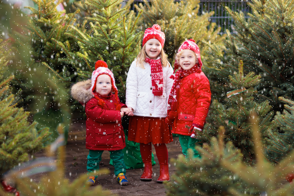 Kids smiling as snow is falling down at Moorpark Christmas tree farm