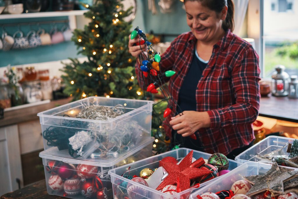 91320 storage experts share storing tips for holiday decoration. Decorating Christmas Tree with Ornaments and Christmas Lights