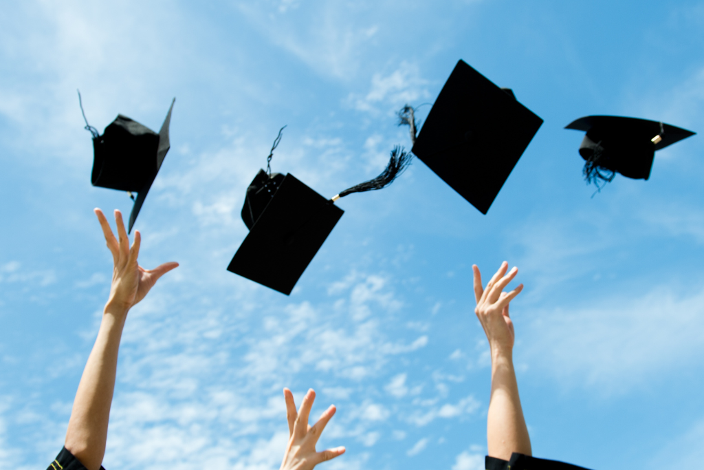 graduation caps being thrown in the air